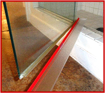 Shower Door Drip Rail photo showing 3M-VHB Transparent Tape film liner partly removed and transparent drip rail. 36" (.914m) length, 2" flange.